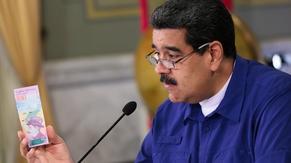 Mr Maduro showing new denomination notes that are to be released next month