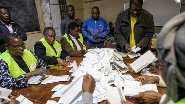 Ballot papers are poured onto a table in Harare as the counting of the votes begins during the Zimbabwean General Election