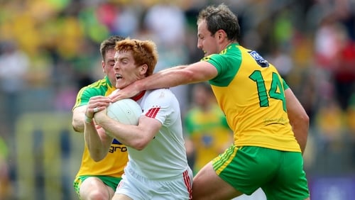 Tyrone's Peter Harte tackled by Michael Murphy for Donegal