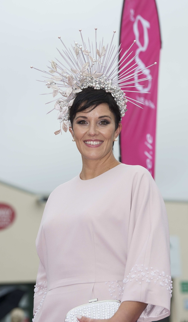 Suzanne Burke wore a soft blush pink with a striking headpiece.