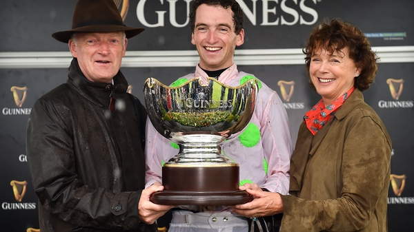 Jockey Patrick Mullins celebrates with father and trainer Willie and mother Jackie after winning the Guinness Galway Hurdle Handicap