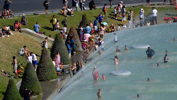 People cool off at the Trocadero Fountain in the French capital Paris