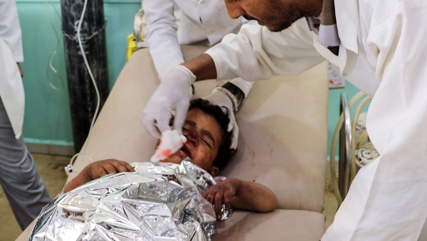 A child is treated by medics following the air strikes in Saada