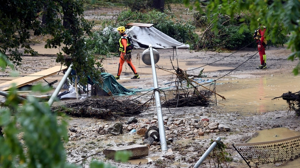 Rescue workers sift through the debris following the floods