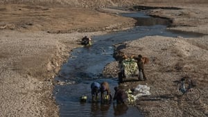 People are seen washing cabbage in a river near Raksan (file image)