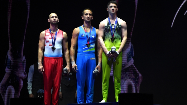 Rhys McClenaghan on the podium receiving his gold medal in Glasgow