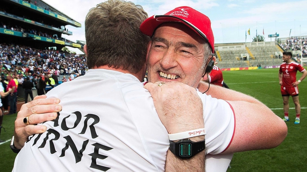 Mickey Harte embraces Tyrone assistant manager Greg Devlin after their defeat of Monaghan