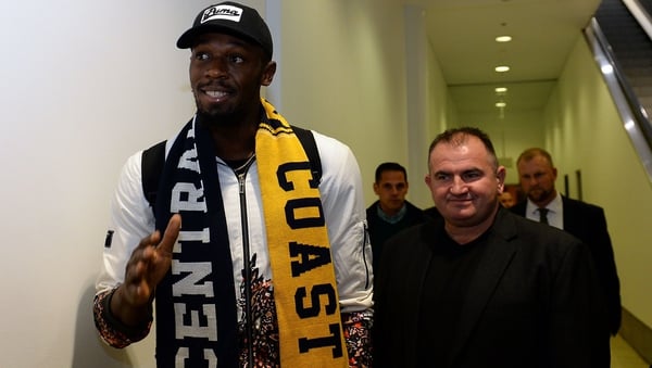 Usain Bolt makes his way through security as he arrives at Sydney international airport
