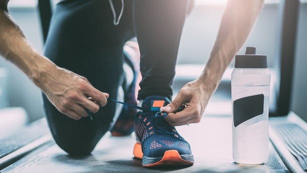 Portrait of a man tying shoelaces