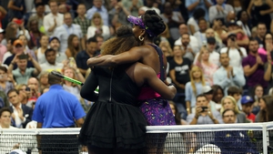 The Williams sisters embrace at the end of their game
