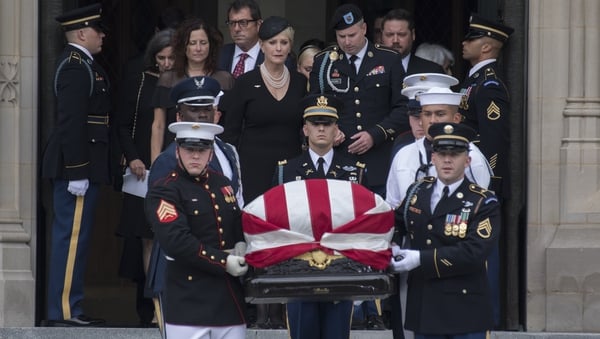 John McCain's wife Cindy, and their son Jimmy, follow an honour guard carrying his casket out of the the National Cathedral in Washington