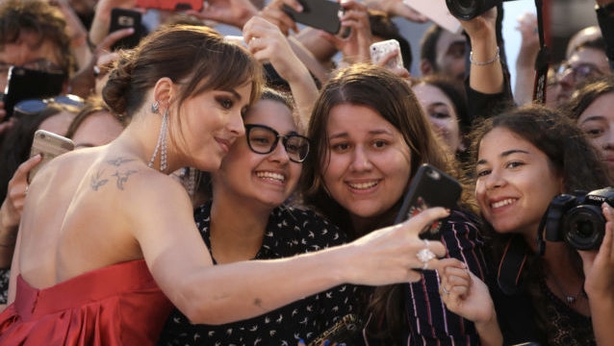 Dakota Johnson takes a selfie with fans at the premiere of Suspiria (Kirsty WigglesworthAPPA)