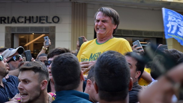 Jair Bolsonaro reacts after being stabbed in the stomach during a campaign rally