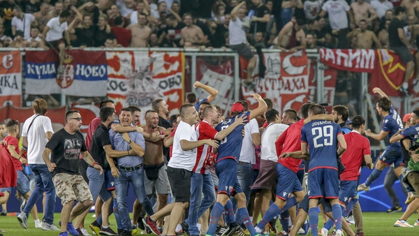 Red Star Belgrade fans invade the pitch after the UEFA Champions League defeat of FC Salzburg