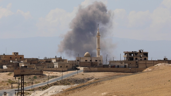 Smoke billows following Syrian government forces' bombardment around the town of Khan Sheikhun on the southern edge of Idlib