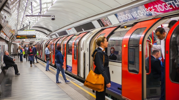 People waiting at underground tube platform for train arrives