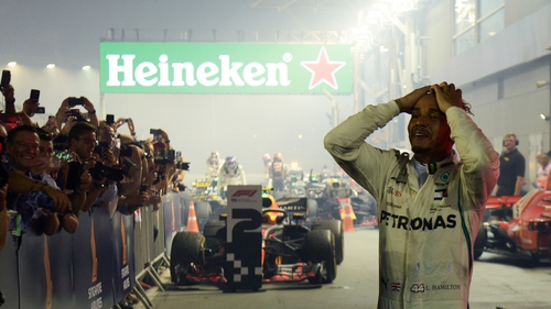 Lewis Hamilton celebrates with pit crew after winning the Singapore Grand Prix