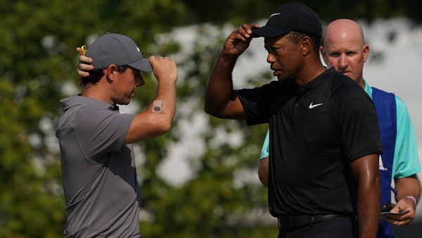 Rory McIlroy (L) and Tiger Woods will face off in Atlanta