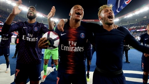Kylian Mbappe celebrates with the match ball and Neymar after the historic victory