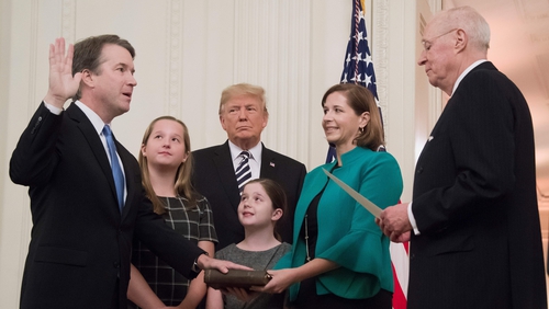 Brett Kavanaugh (L) is sworn-in as Associate Justice of the US Supreme Court with now-formerUS President Donald Trump nearby
