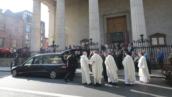 The coffin of Emma Mhic Mhathúna is carried from St Mary's Pro-Cathedral following her funeral mass