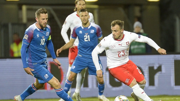 Iceland's midfielder Gylfi Sigurdsson (L) tries to close down Switzerland's Xherdan Shaqiri