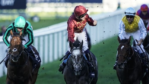 Oisin Murphy celebrates after riding Roaring Lion (C, maroon) to win The Queen Elizabeth II Stakes at Ascot