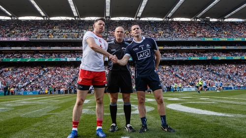 Conor Lane with Tyrone captain Matthew Donnelly (L) and Stephen Cluxton of Dublin (R) before the All-Ireland final