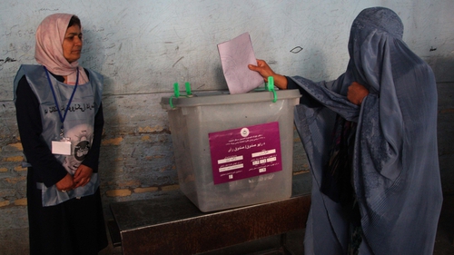 A woman casts her vote at a polling station during the parliamentary elections in Herat