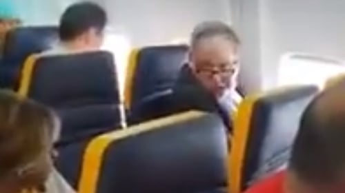 The man (seated by the window) yelled abuse at the woman passenger