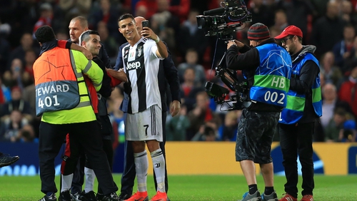 Ronaldo takes a selfie with one of the Old Trafford pitch invaders