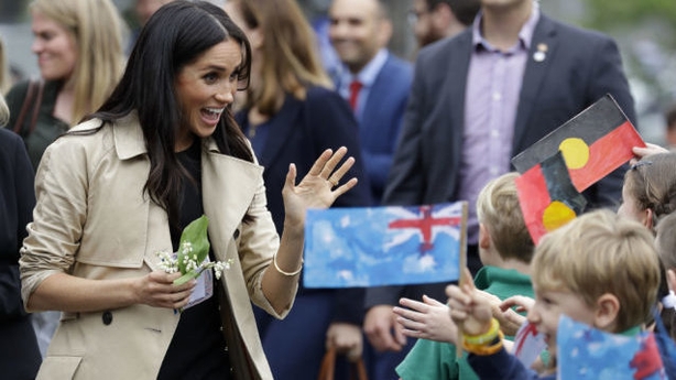 The Duchess of Sussex waves at children during a visit to Albert Park Primary School in Melbourne (PA)