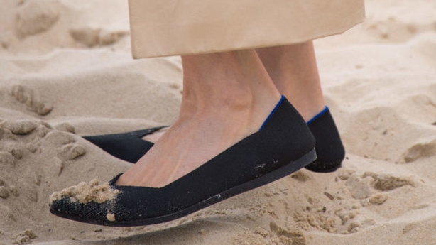 Sand on the Duchess of Sussex's shoes as she walks on South Melbourne Beach (PA)