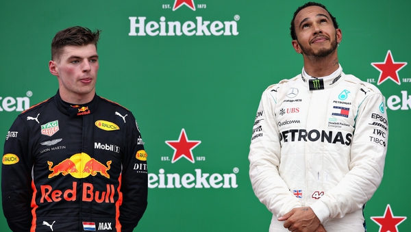 Lewis Hamilton celebrates on the podium alongside second-placed Max Verstappen