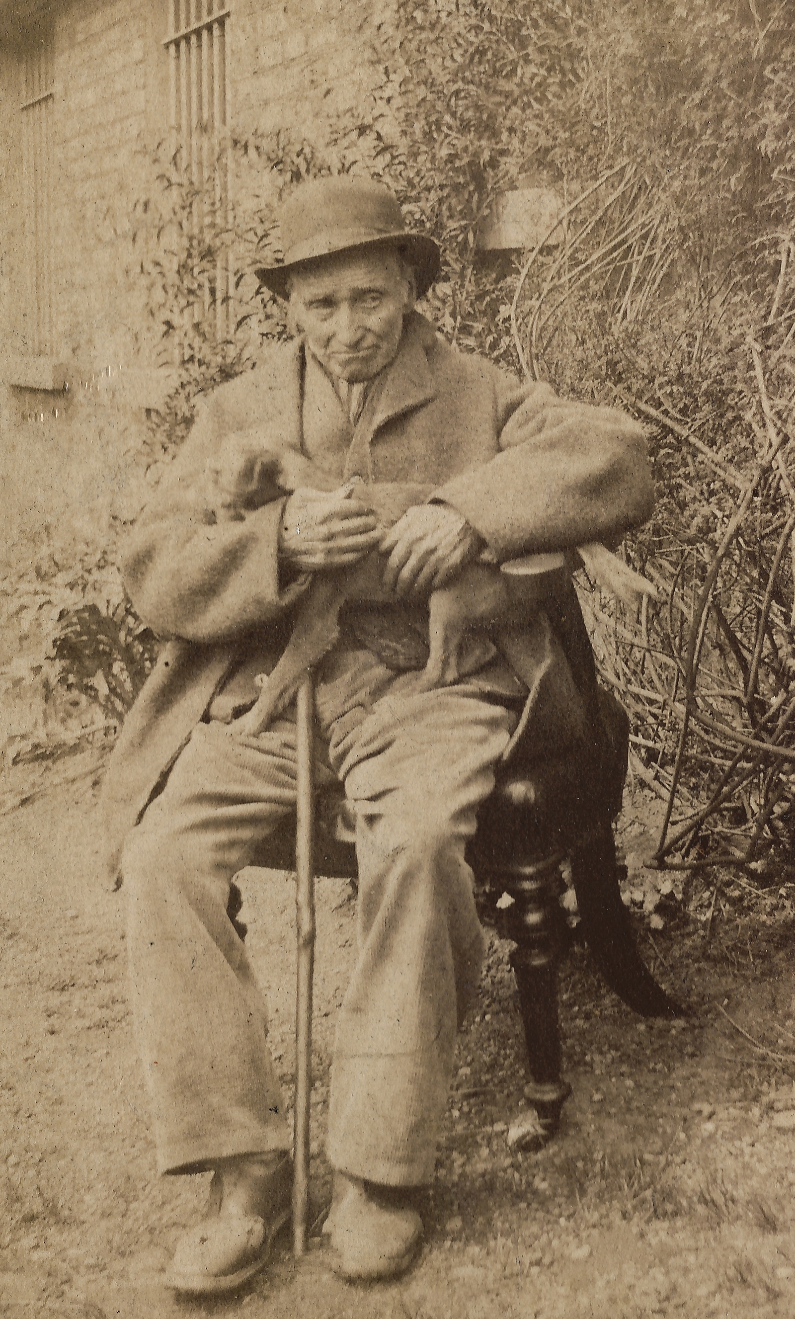 Image - Albumen portrait of James Conway seated outside with cane and hat.