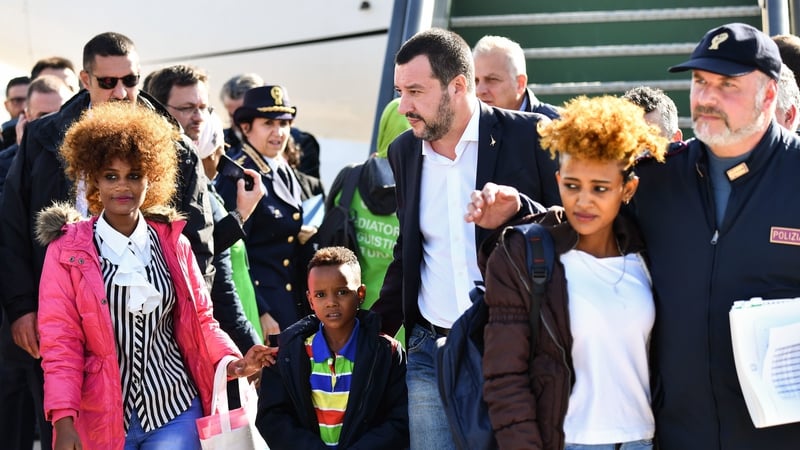 Mr Salvini greeting the migrant group at a military airport near Rome today