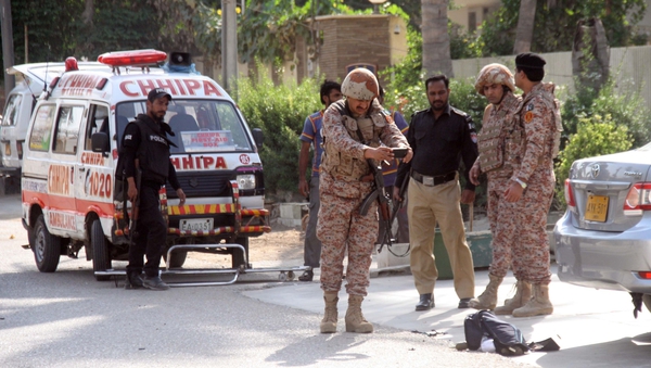 Pakistani security forces outside the Chinese consulate after the armed attack in Karachi