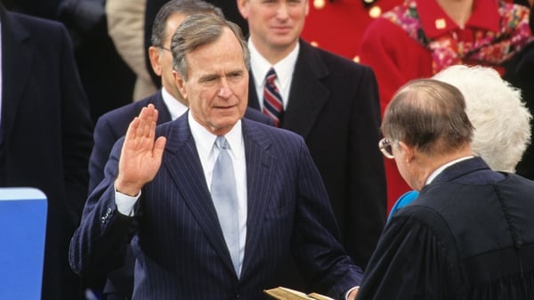 George HW Bush takes the oath of office as he is sworn-in as 41st President of the United States in 1989