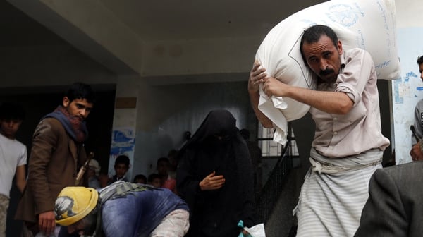 Conflict-affected Yemenis receive rations of food aid provided by the World Food Programme