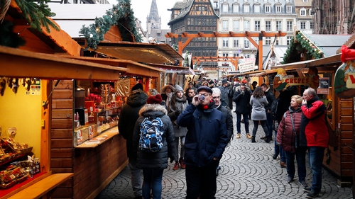 People visit the reopened Christmas Market, in Strasbourg, France, today