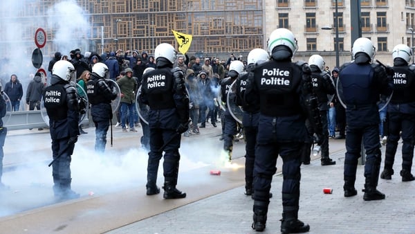 Police officers step in to disperse around 1,000 far-right, anti-migration protesters near EU buildings in Brussels