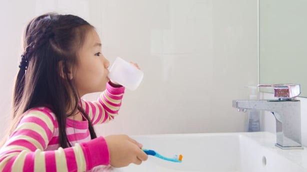 child brushing teeth