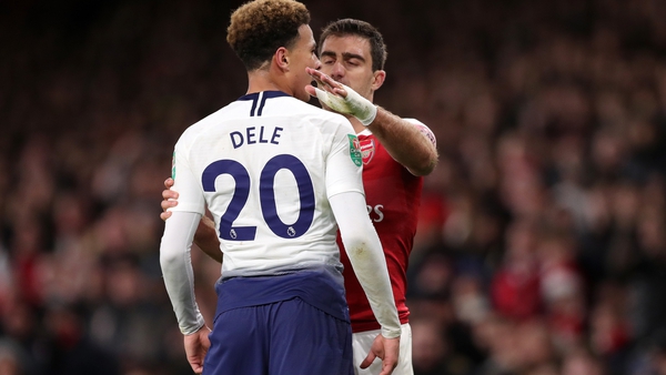 Dele Alli reacts after being hit by a bottle