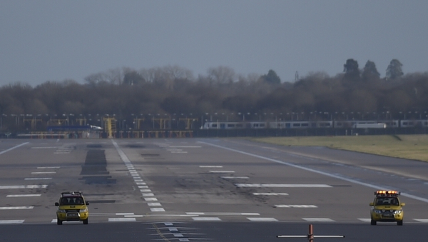 Service vehicles on the runway as flights at Gatwick Airport are halted