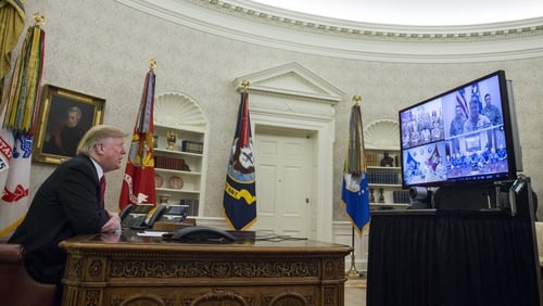 Donald Trump makes a video call to service members from the Oval Office