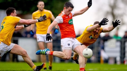 Antrim's Declan Lynch and Michael McCarry try to tackle Jack Grugan of Armagh