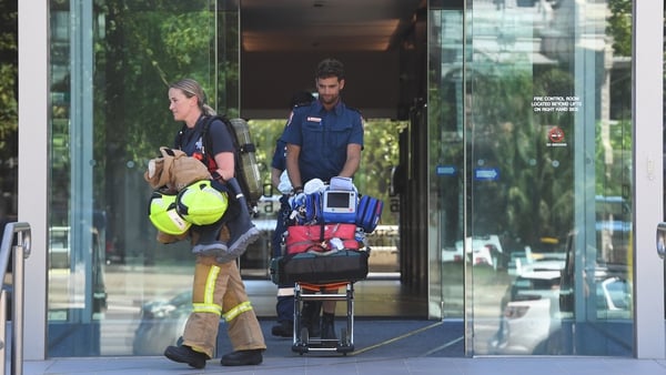 Emergency service personnel leave the building where the Korean consulate is located in Melbourne