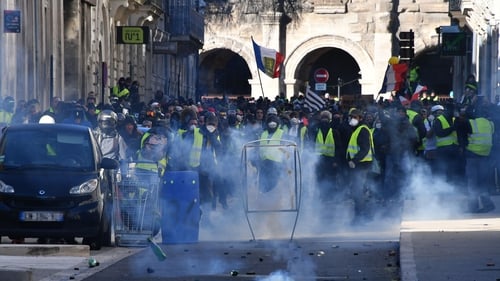 Tear gas is thrown at protesters in Paris