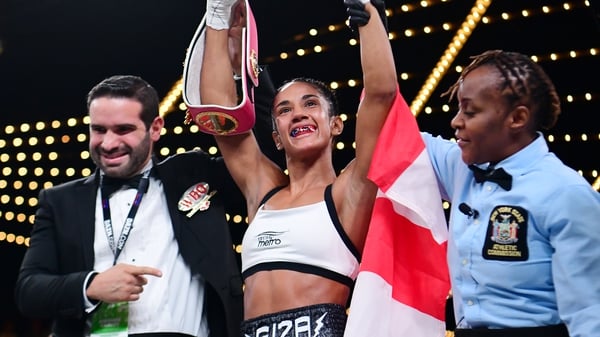 Amanda Serrano has her hand hoisted as she secured the super flyweight world title