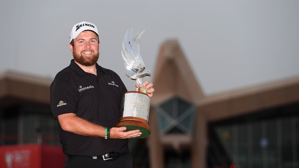 Shane Lowry celebrates with the trophy for winning the Abu Dhabi HSBC Championship